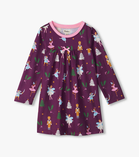 Front view of girls purple Nutcracker nightdress with pink neckline, bow, and ballerina, fairy, soldier, mouse print