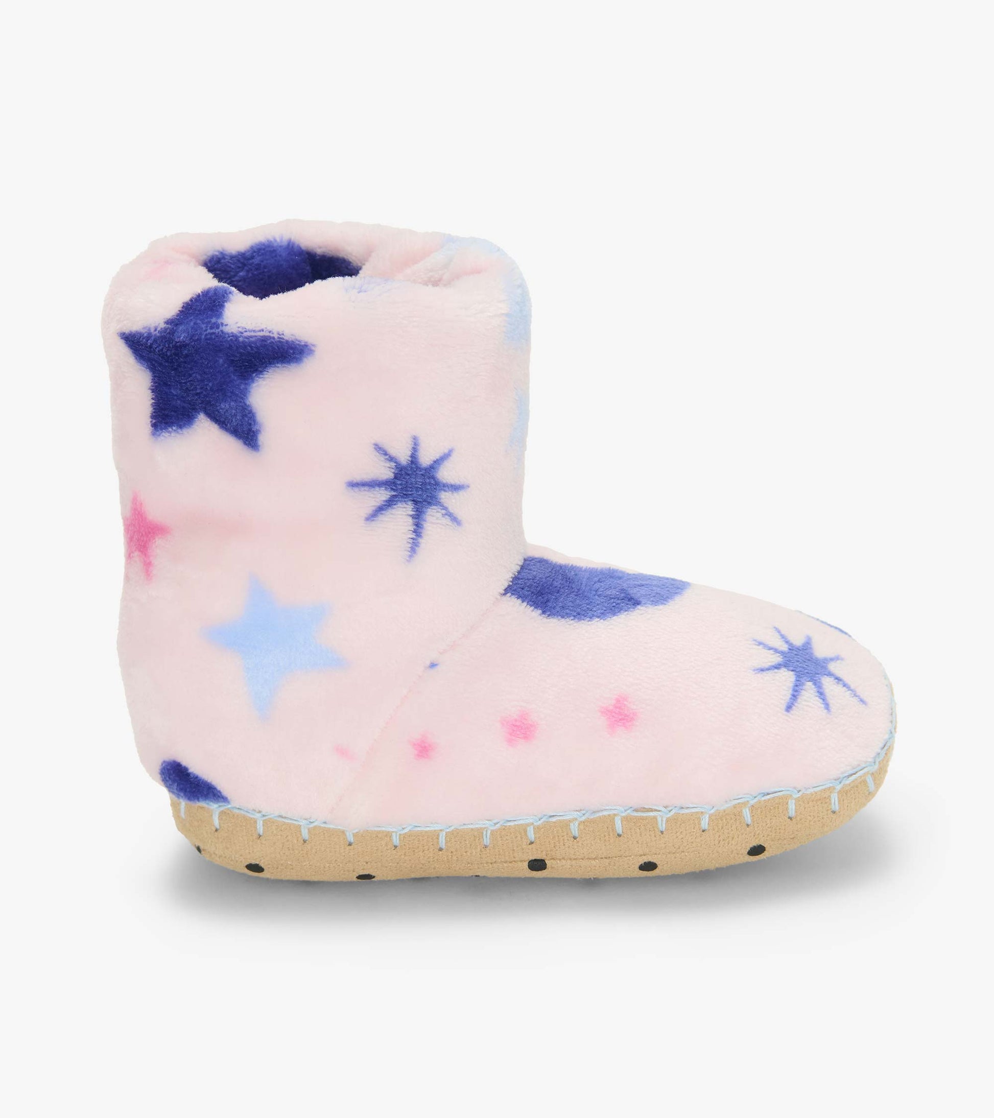 Side view of a pink slipper boot with blue and pink star print and tan sole
