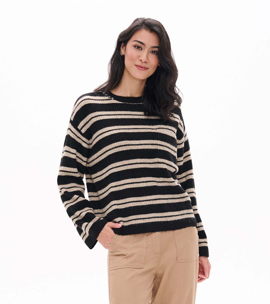 Front view of black and oatmeal striped sweater with crew neck and long sleeves on model
