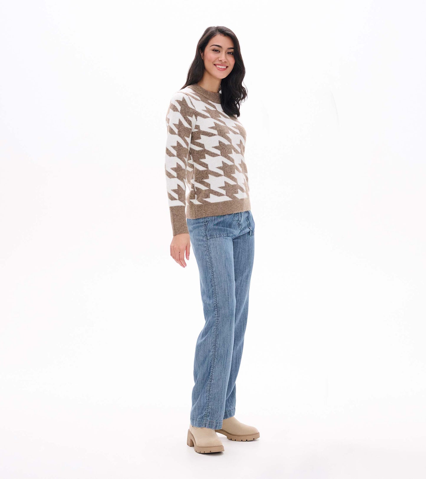 Side view of oatmeal and cream herringbone sweater with crew neck and ribbed hem