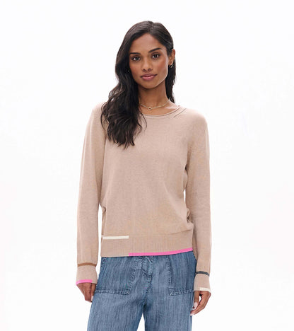 Front view of oatmeal crew neck sweater with long sleeves and pink, cream, tan, and gray trim accents