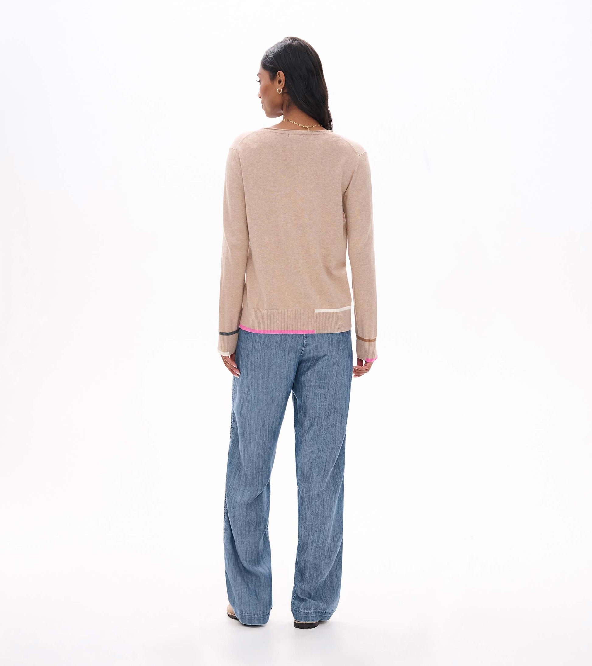 Back view of oatmeal crew neck sweater with long sleeves and pink, cream, tan, and gray trim accents