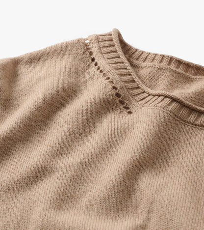 Close-up of oatmeal melange crew neck sweater with ribbed collar and openwork detail at the shoulder