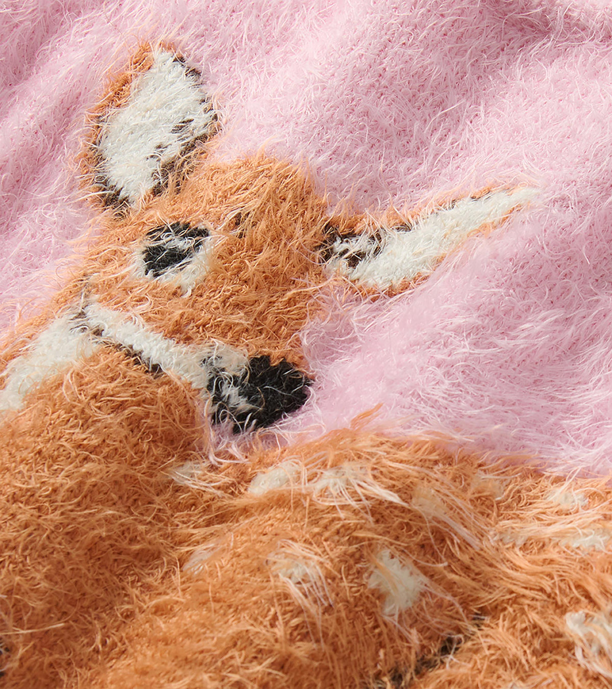 Close-up of the fawn graphic on a pink furry sweater