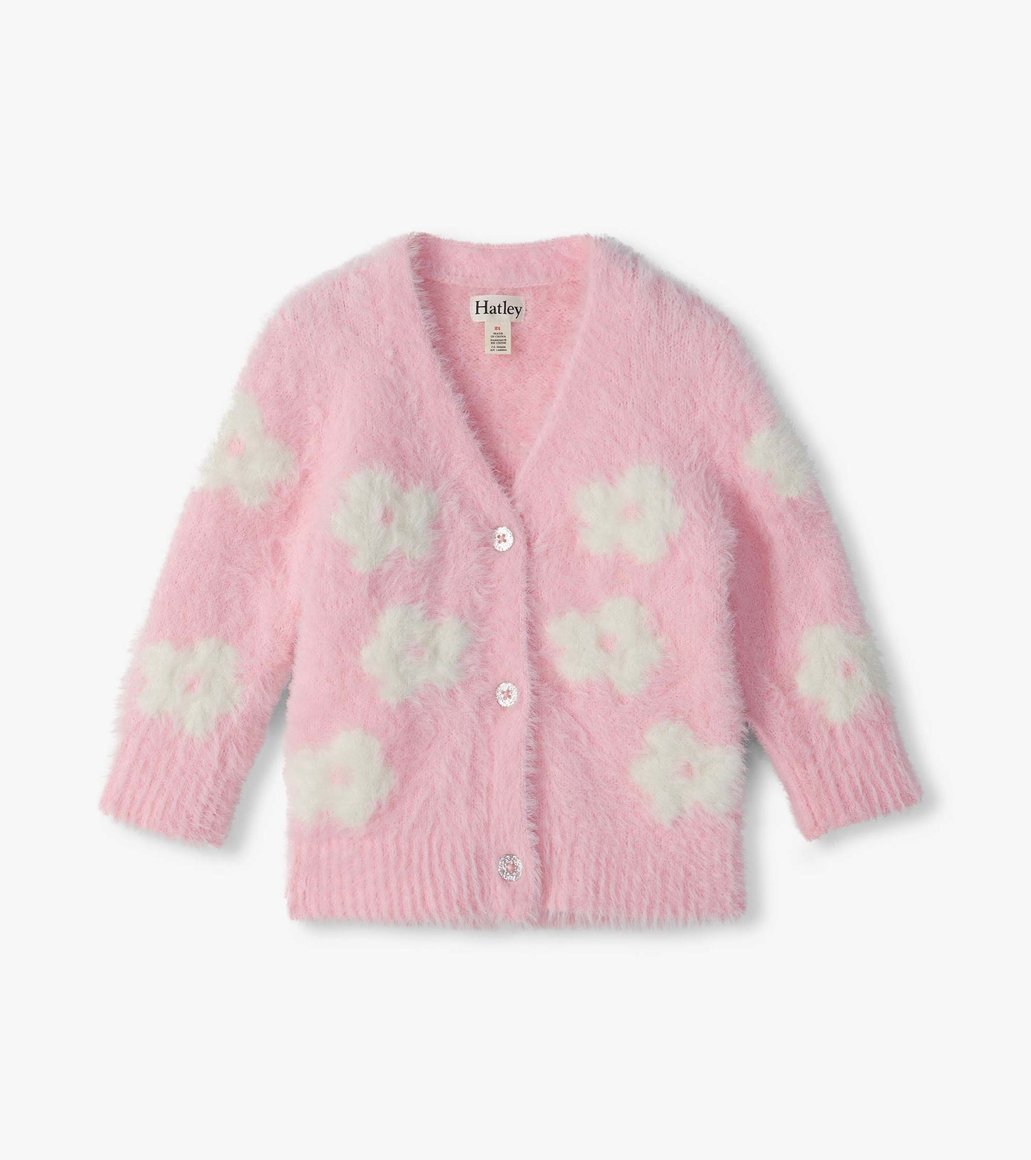 Front view of pink fuzzy cardigan with white flower pattern, V-neck, long sleeves, and button closure