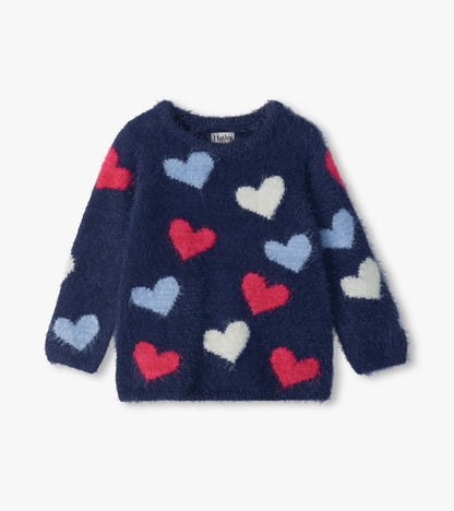 Front view of girls navy sweater with red, light blue, and white heart pattern and long sleeves