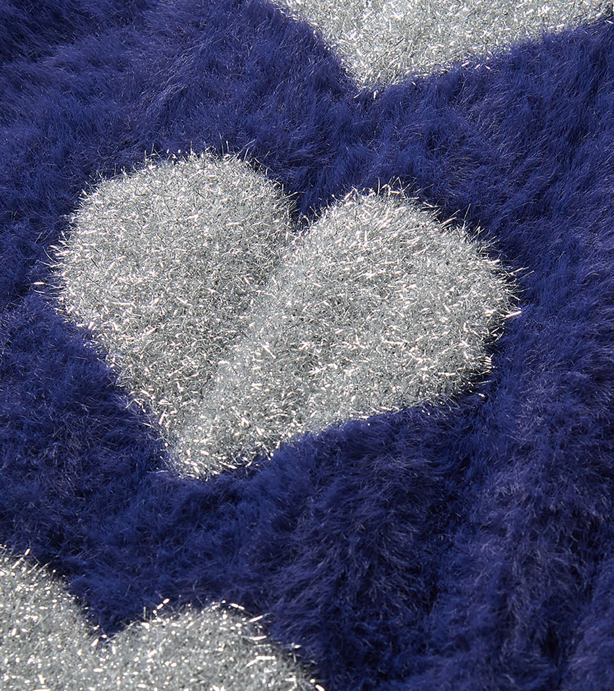 Close-up of silver heart detail on patriot blue fuzzy sweater dress