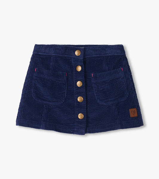 Patriot blue A-line skirt with front snap buttons, two front pockets, and a small logo patch near the hem
