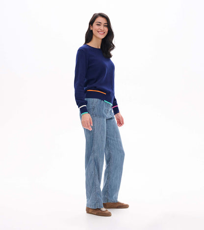 Side view of patriot blue crew neck sweater with colorful trim at hem and cuffs