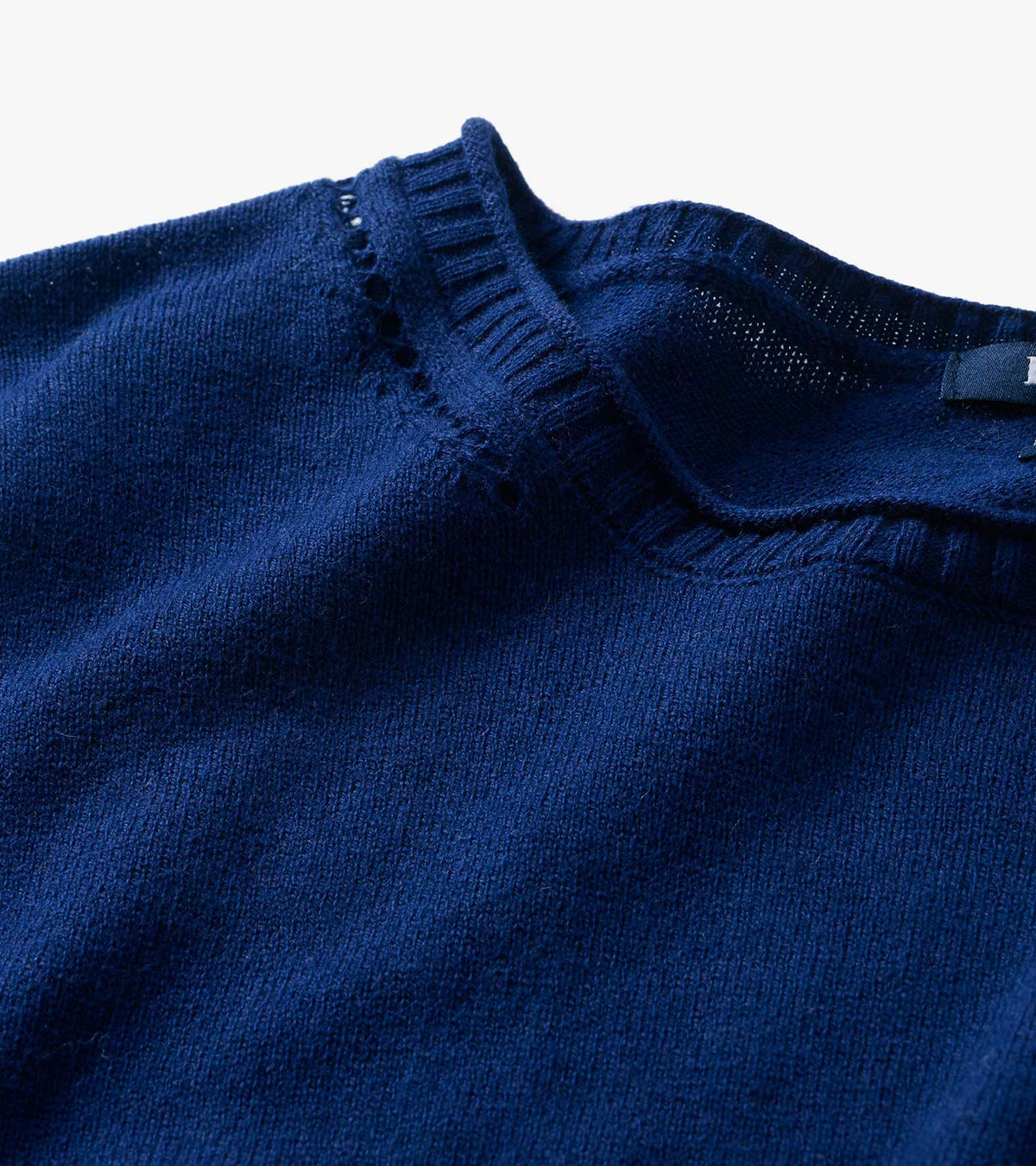 Close-up of patriot blue crew neck sweater neckline with ribbed trim and small openwork detail