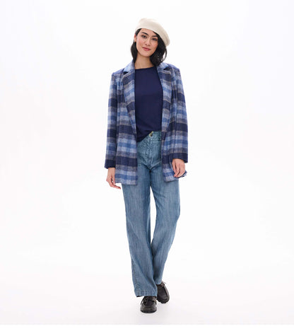 Patriot blue raglan sleeve tee layered under a blue plaid coat with a cream beret