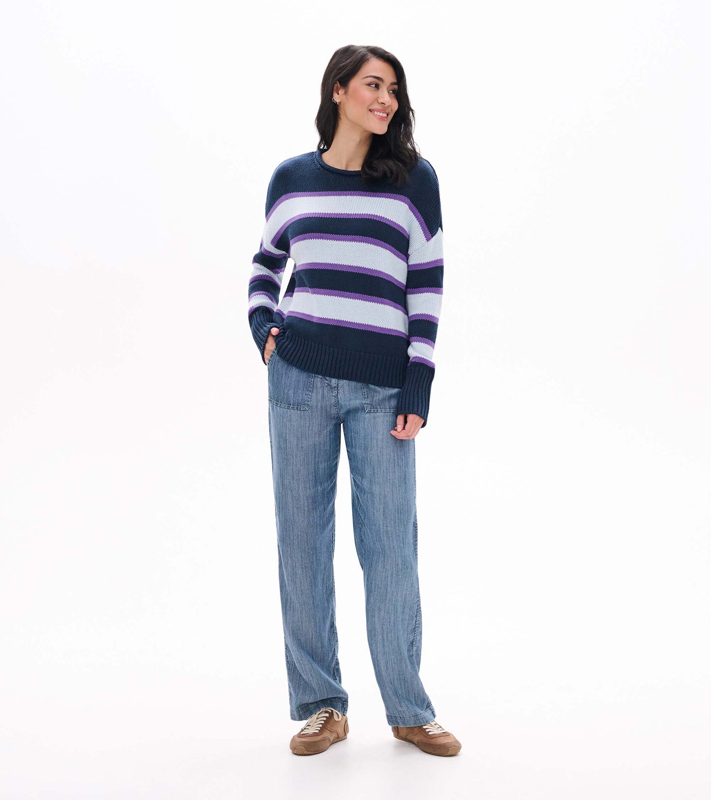 Full front view of striped rolled collar sweater styled with wide leg jeans