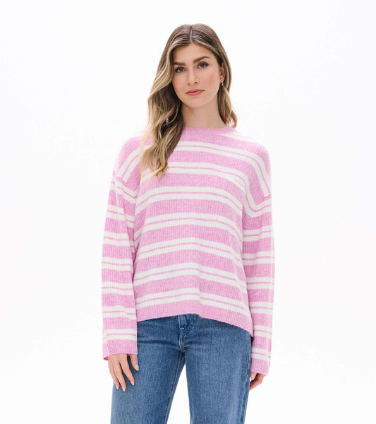 Front view of pink and cream striped sweater with crew neck and long sleeves, worn with blue jeans
