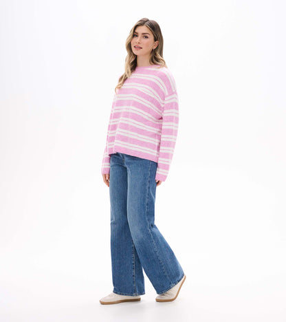 Side view of pink and cream striped sweater with crew neck and slightly dropped shoulders