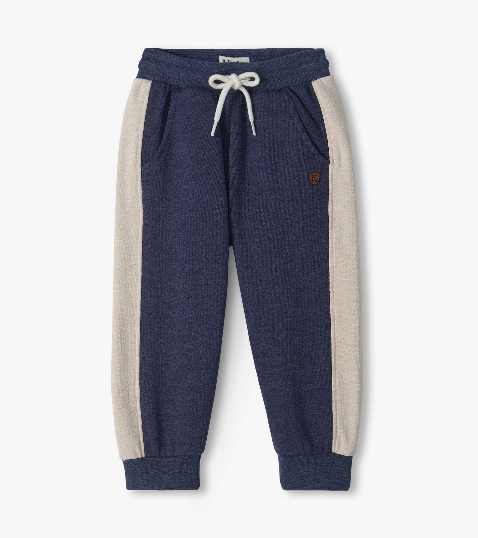 Blue melange track pants with cream side panels, white drawstring waist, front pockets, and cuffed ankles