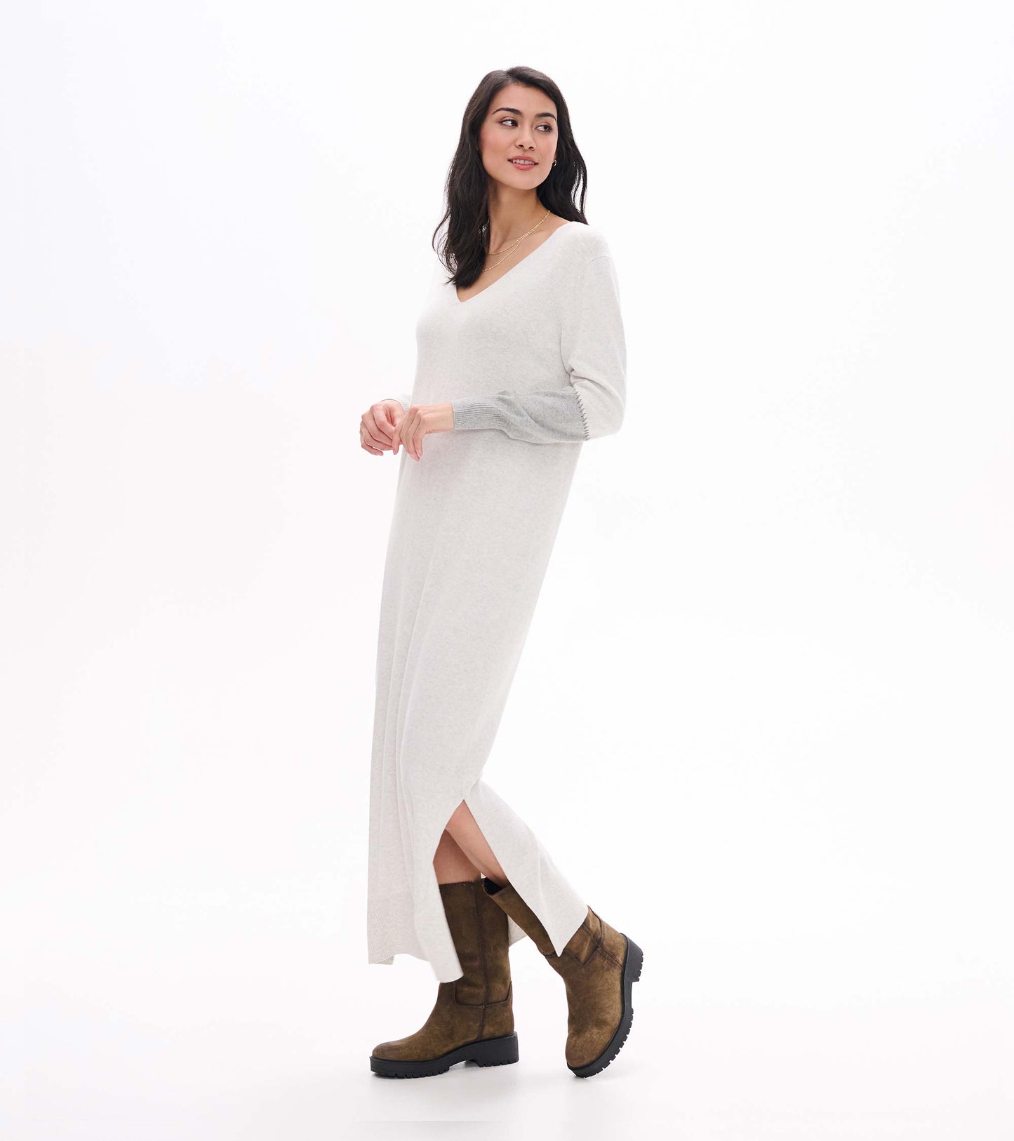 Side view of pale grey melange maxi sweater dress showing V-neck, side slit, and contrast sleeve detail