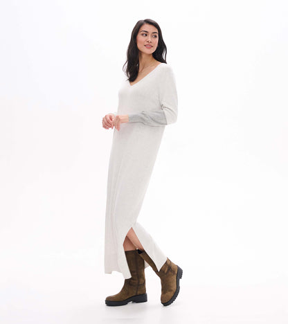 Side view of pale grey melange maxi sweater dress showing V-neck, side slit, and contrast sleeve detail