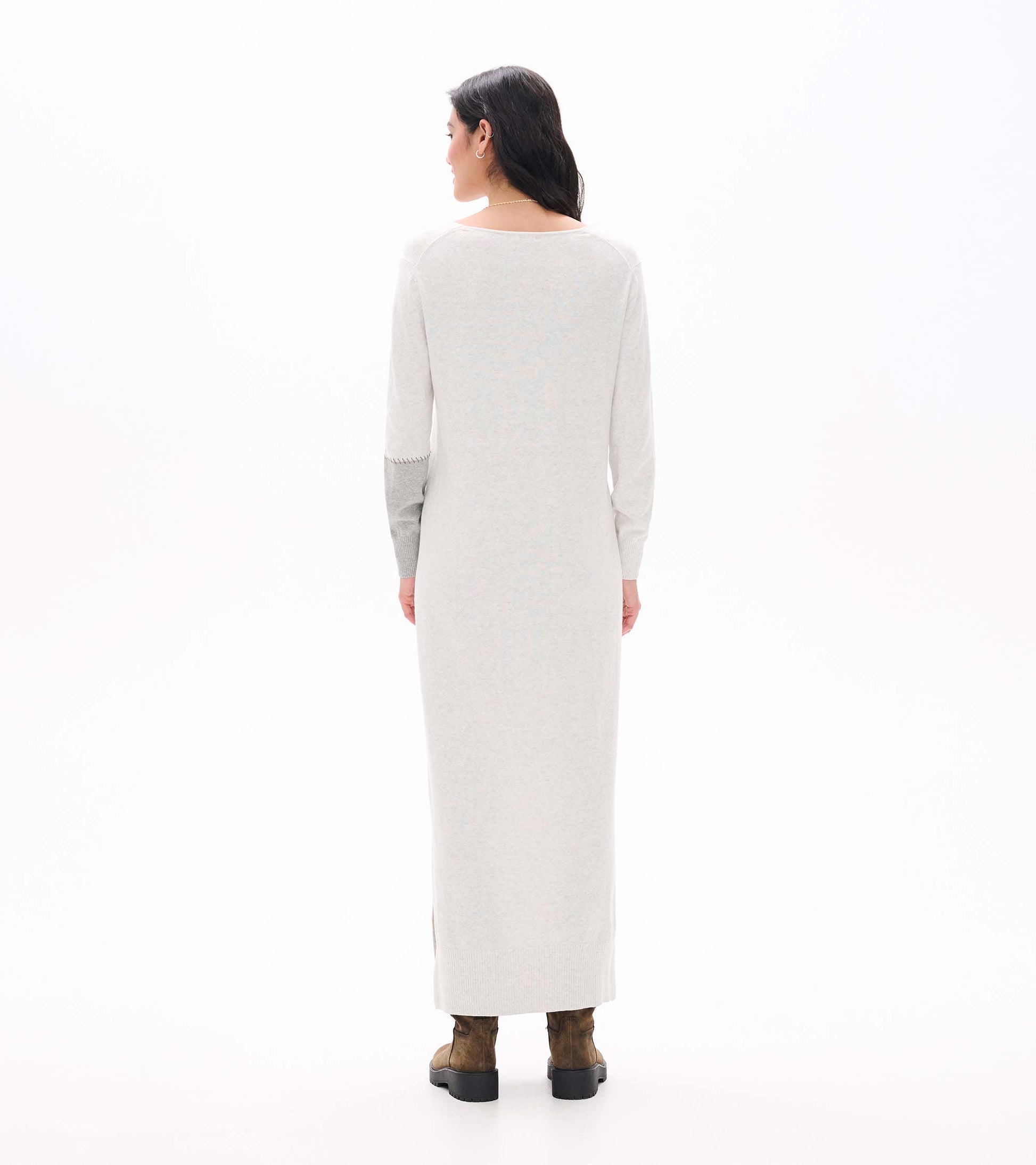 Back view of pale grey melange maxi sweater dress with long sleeves and contrast right sleeve panel