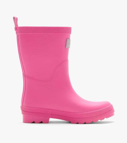 Single pink matte rain boot in side profile with textured top edge, pull tab, and lug sole
