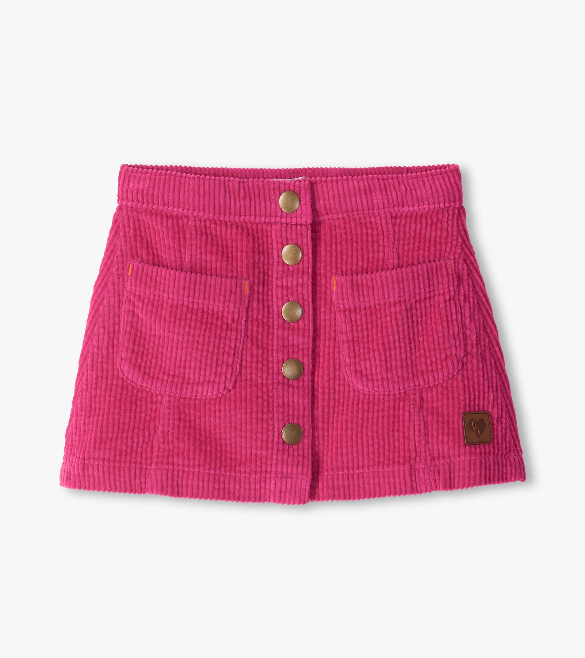 Pink A-line skirt with ribbed texture, front snap buttons, front pockets, and a small logo patch near the hem