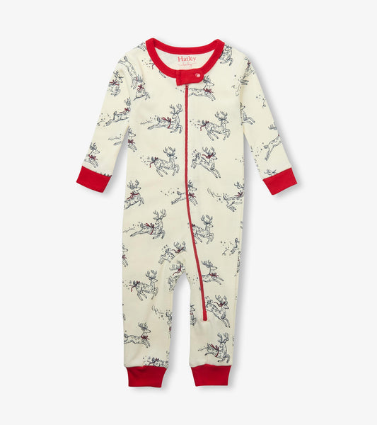 Front view of baby sleeper with red trim and zipper, cream color with leaping deer and star print
