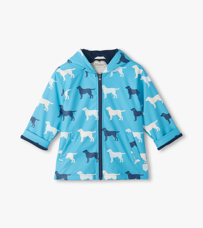 Front view of blue hooded rain coat with white and navy dog silhouettes, zip closure and front pockets