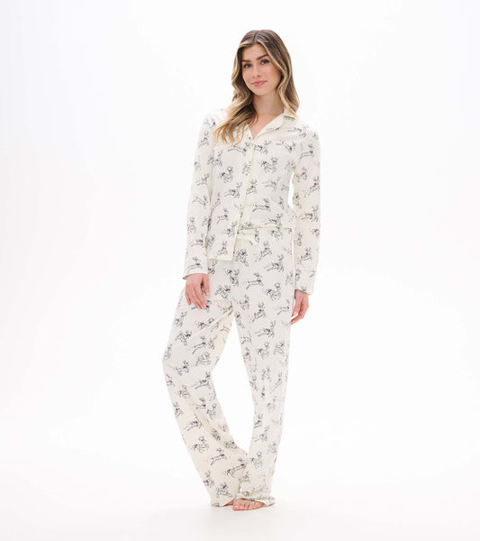 Front view of button-up pajama set in cream with scattered prancing reindeer print and long pants