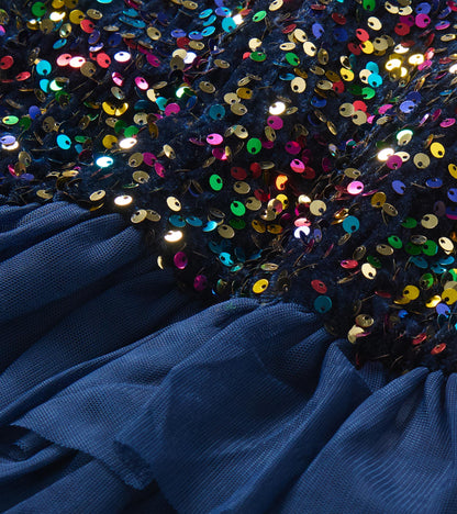 Close-up of multicolor sequins on navy bodice with gathered navy tulle tiers