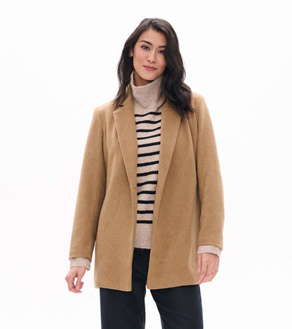 Model wearing camel open jacket with notched lapels, front view over striped turtleneck