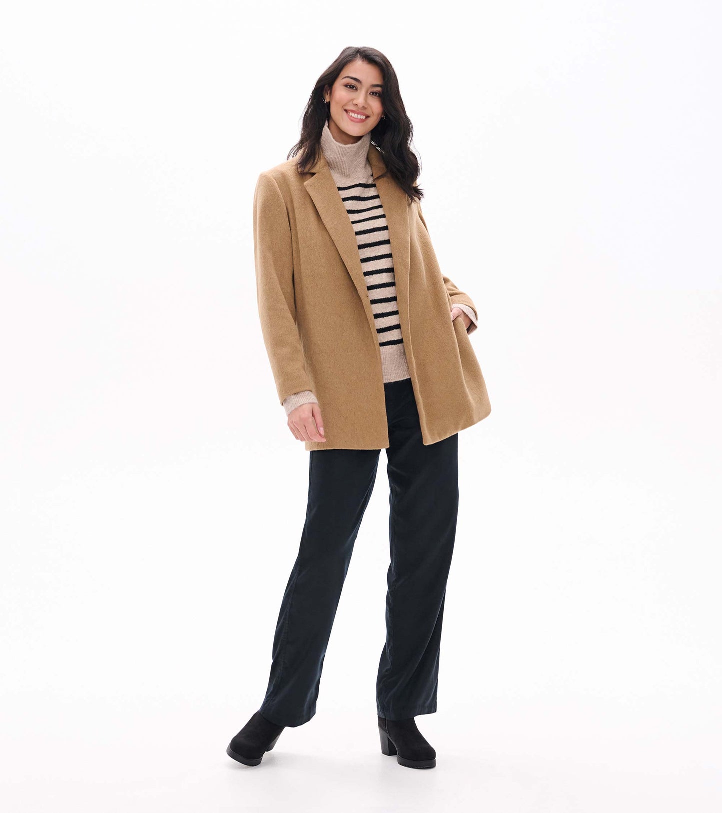 Model wearing camel open jacket, full-length front view over striped turtleneck and black pants