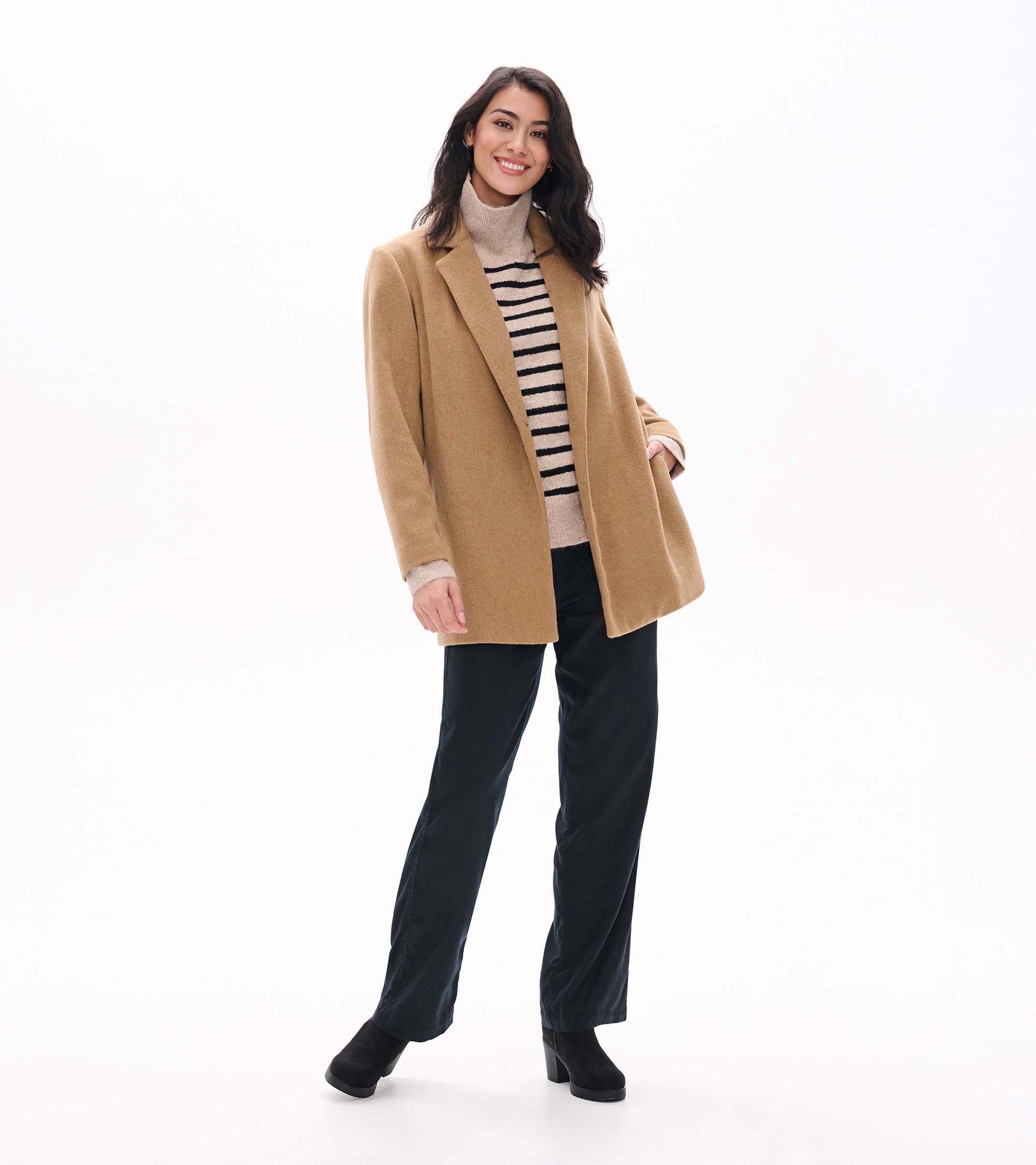 Model wearing camel open jacket, full-length front view over striped turtleneck and black pants