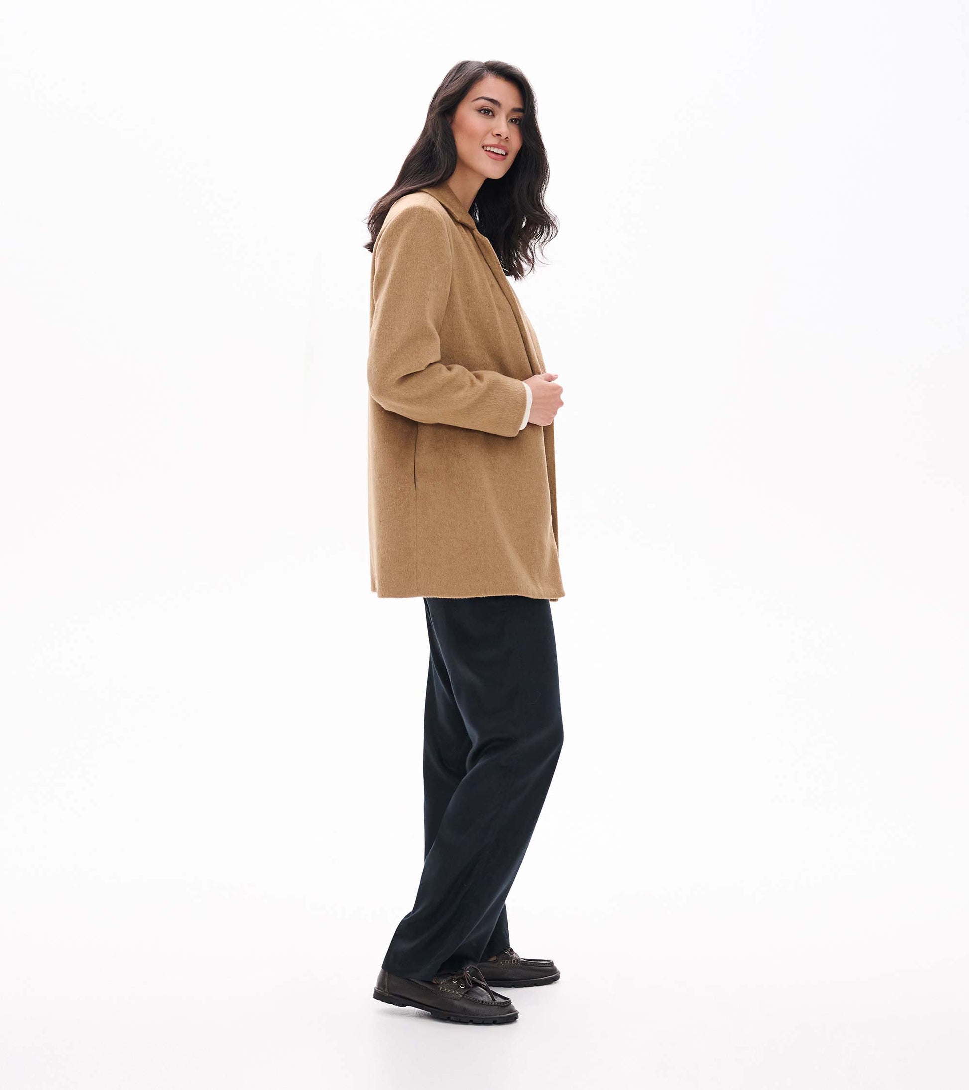 Side view of camel open jacket on model with straight silhouette and notched lapels