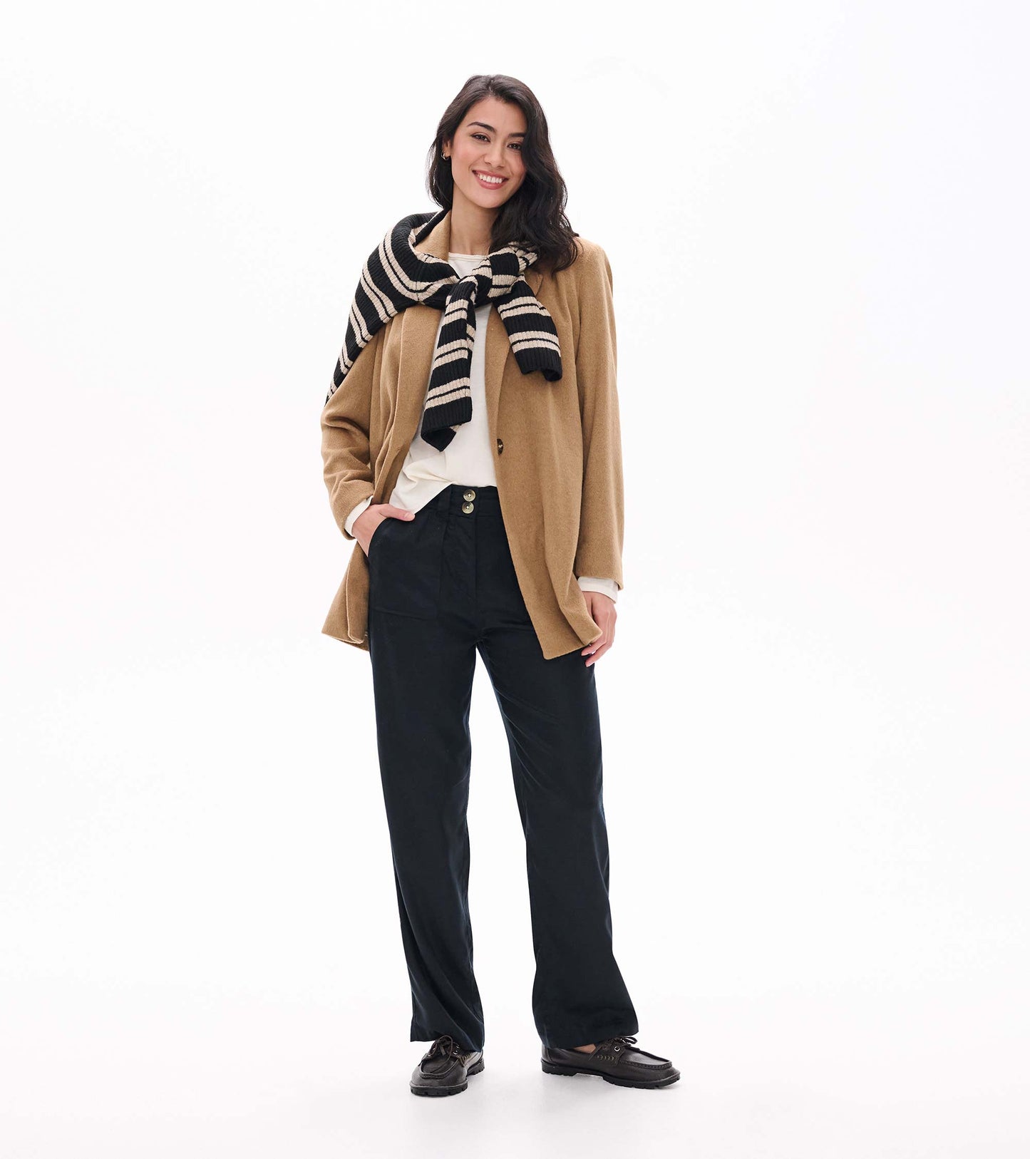Burro brown open jacket styled with black pants and a black-and-cream striped sweater draped over shoulders