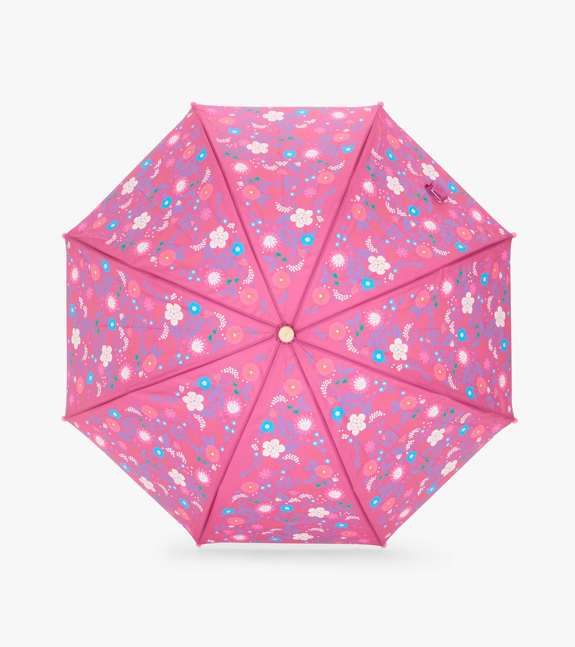 Top view of open pink umbrella with tiny multicolor flowers across all panels