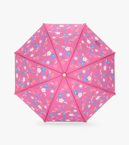 Top view of open pink umbrella with tiny multicolor flowers across all panels