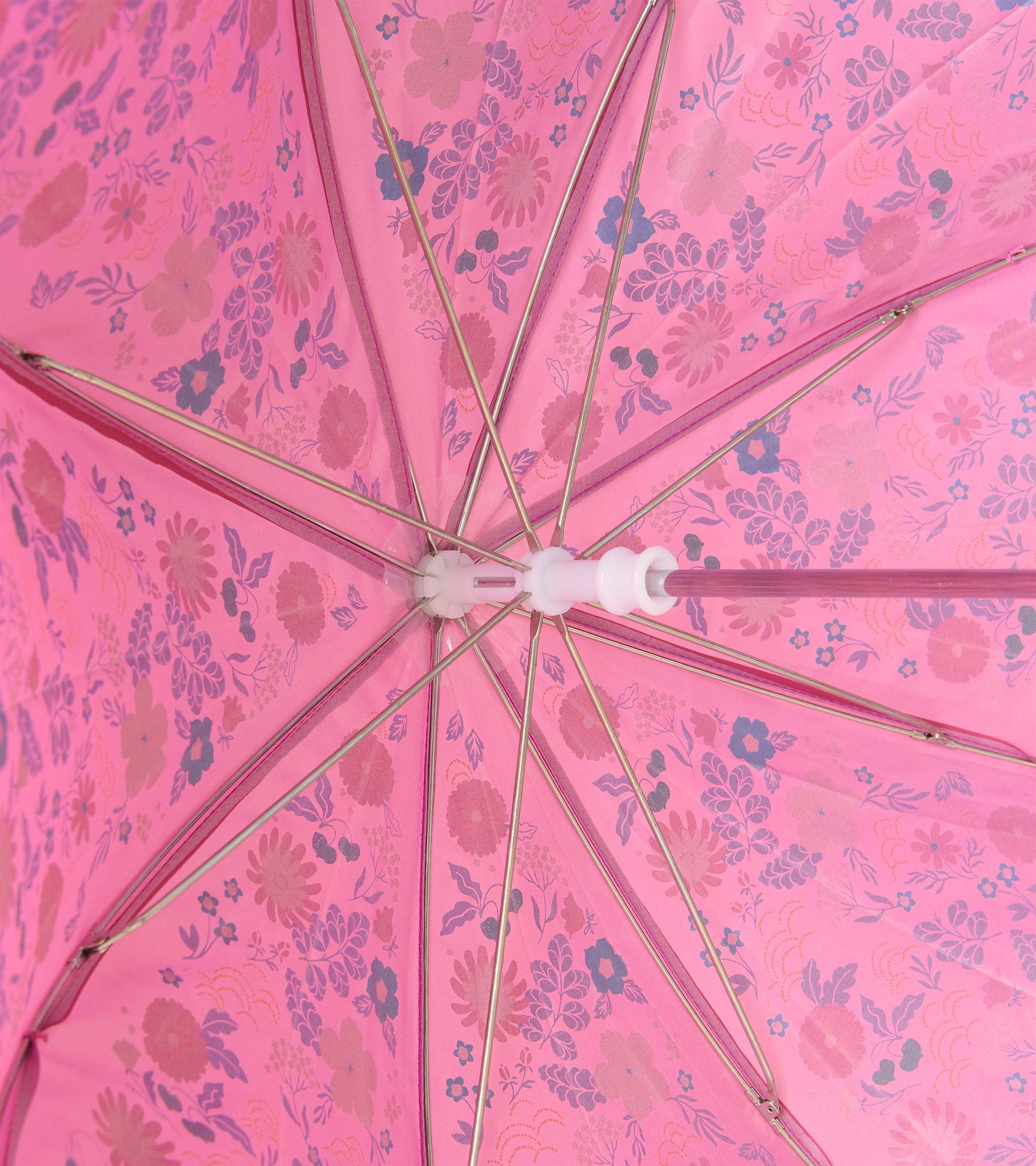 Interior view of pink floral umbrella showing metal ribs and pink shaft