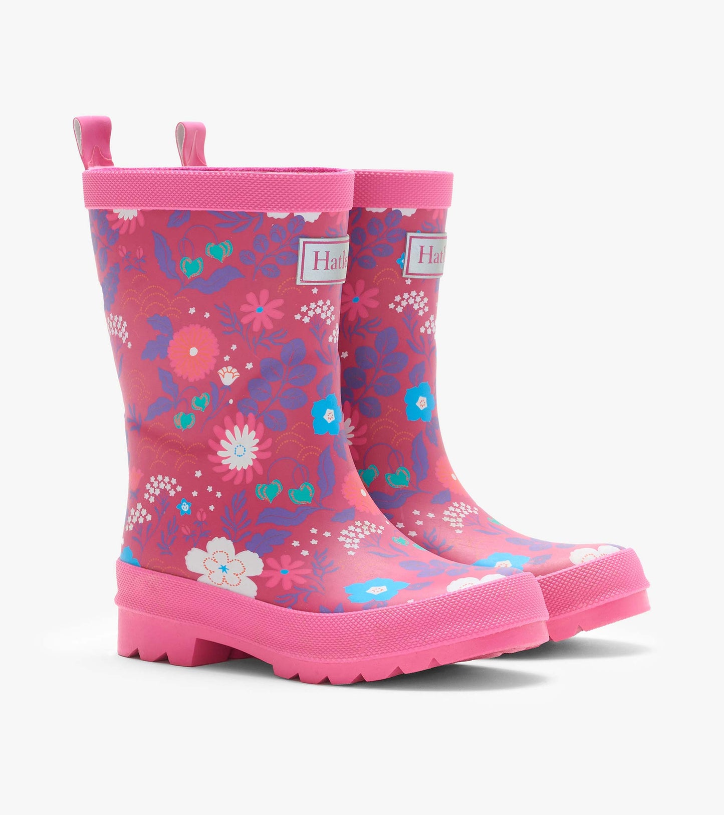 Pair of pink kids rain boots with tiny floral print, front angled view, pull tabs, and lug soles