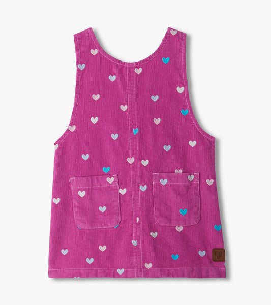 Front view of pink pinafore dress with embroidered hearts and two front patch pockets