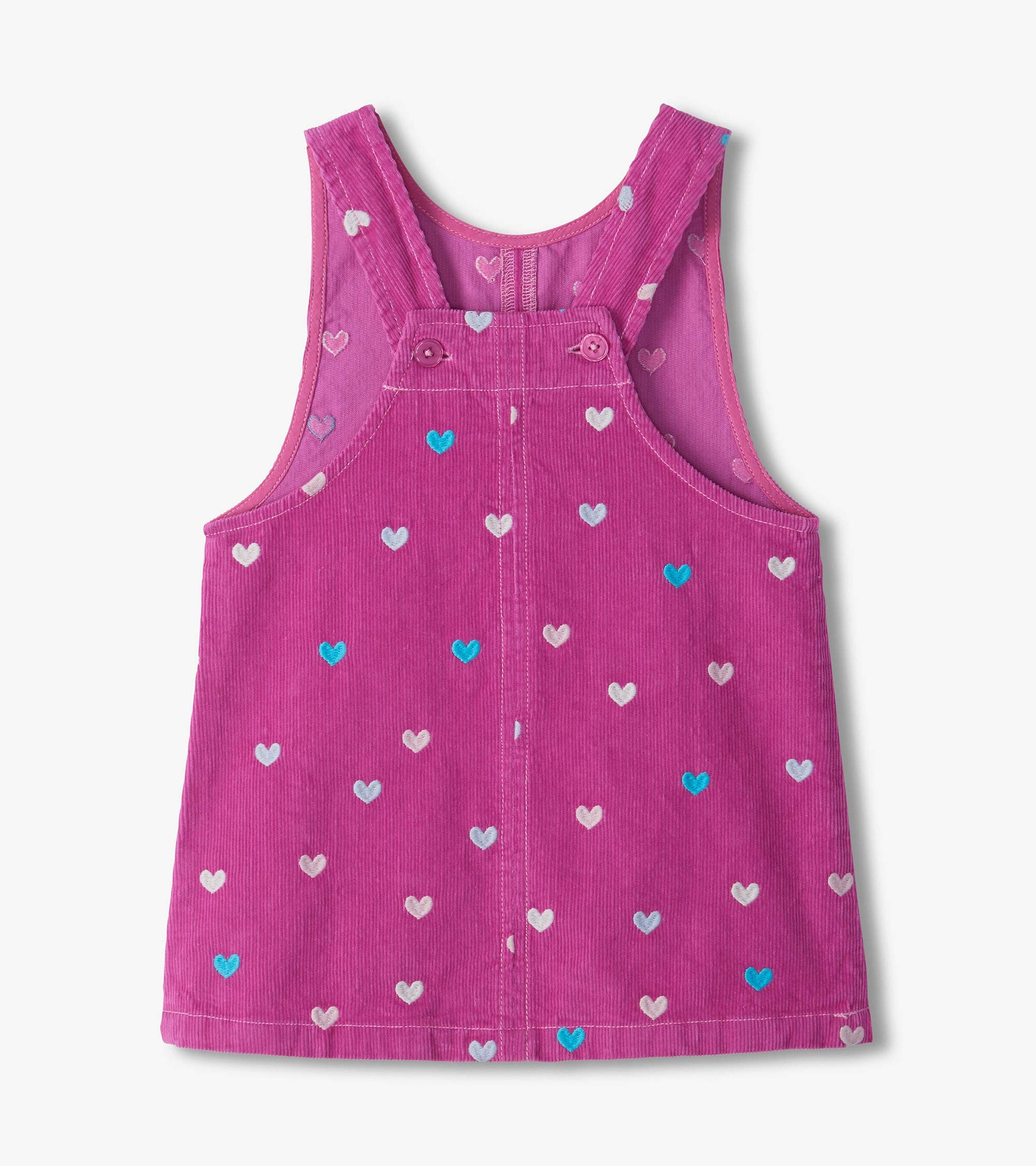 Back view of pink pinafore dress with button straps and embroidered heart pattern