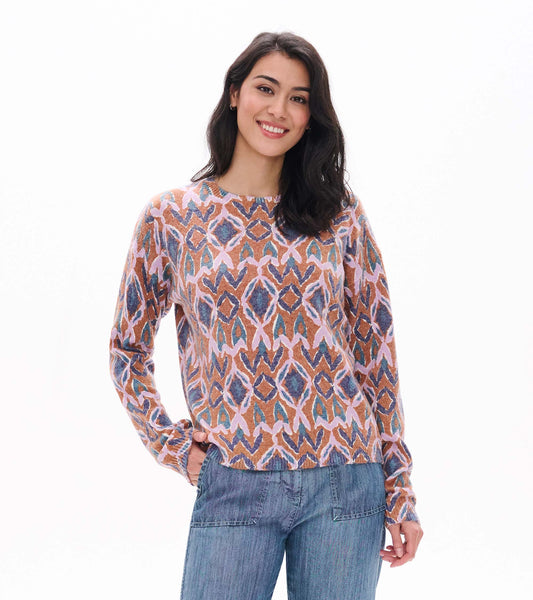 Front view of Noa sweater with pink, blue and rust ikat pattern and long sleeves