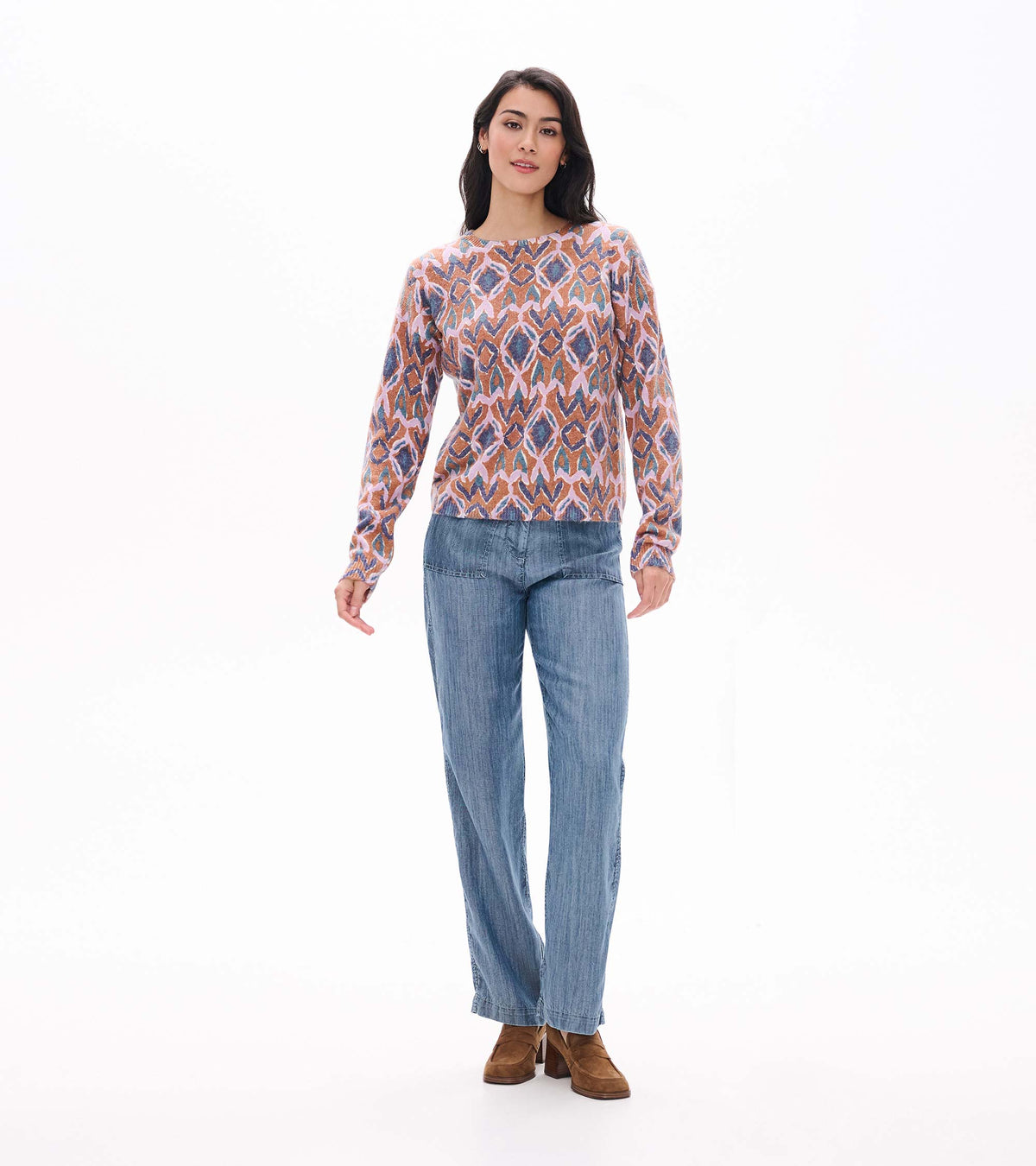 Full front view of Noa ikat sweater styled with wide leg blue pants