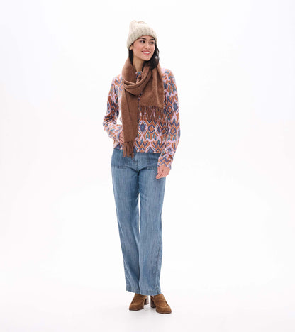 Noa sweater in textured ikat print, shown full length with blue jeans, brown scarf, and knit beanie