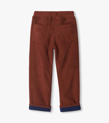 Back view of tortoise brown pull-on pants with two back patch pockets and turned-up navy cuffs