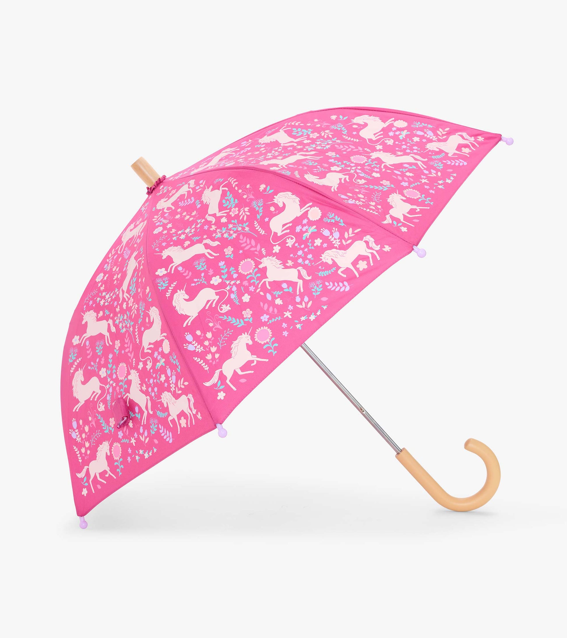 Open pink kids umbrella with white unicorn and floral print, shown at an angle with curved handle