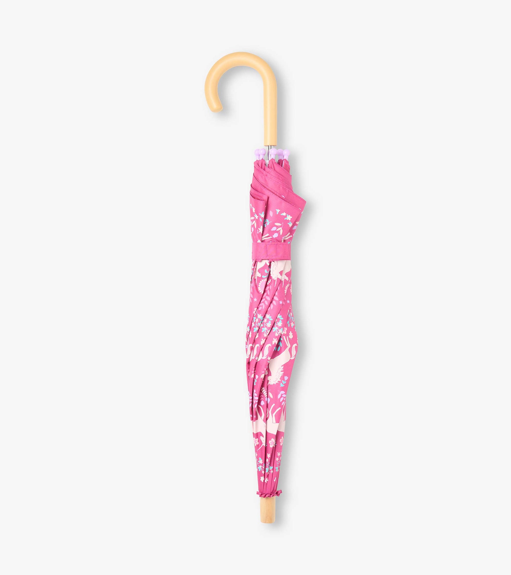 Closed pink unicorn print umbrella with curved wooden-look handle and matching strap