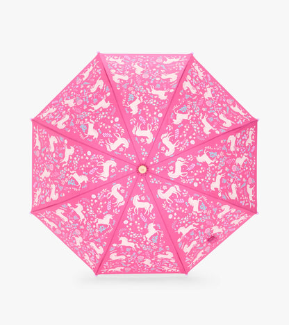 Top view of open pink umbrella with white unicorns and scattered floral pattern