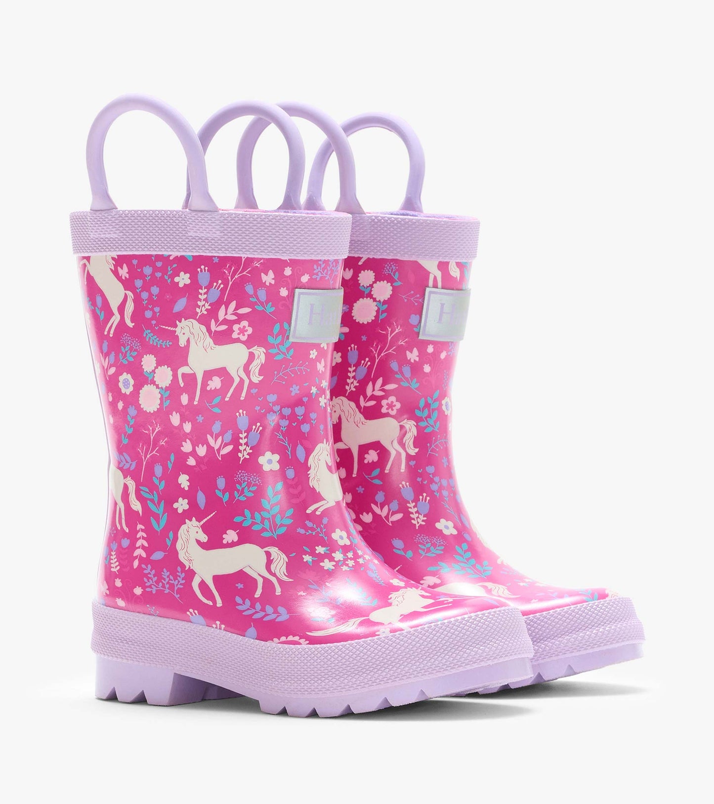 Pair of pink kids rain boots with lavender handles and soles, covered in unicorn and floral print