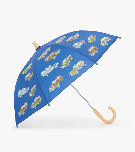 Open blue kids umbrella with vintage truck print and curved beige handle