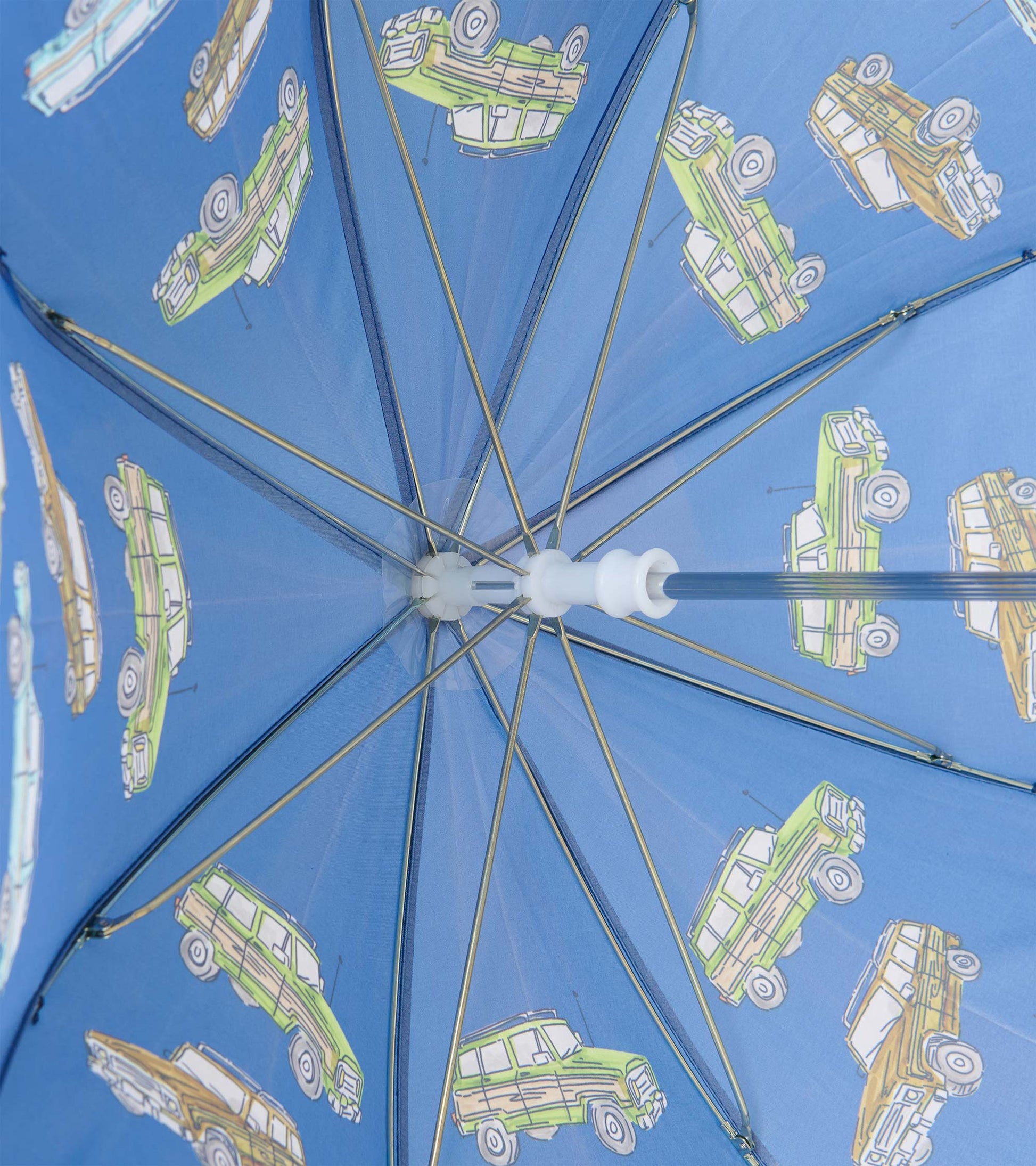 Interior view of blue umbrella showing metal ribs and vintage truck print