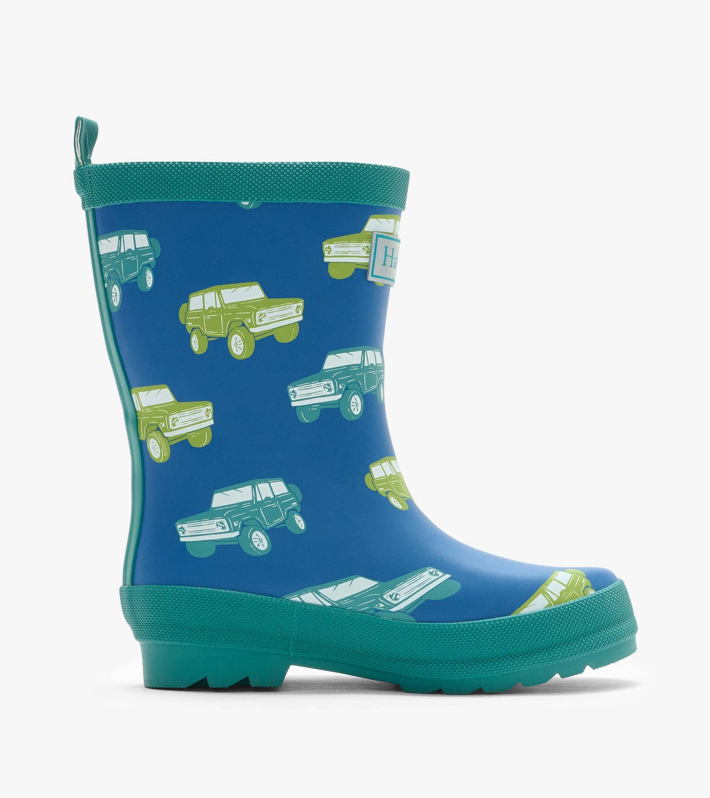 Side view of a blue matte rain boot with green trim and vintage truck print